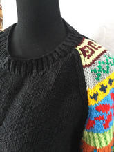 black hand knit pullover with multi color sleeves