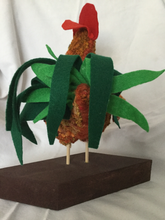 back view of rug hooked rooster sculpture showing green felt tail feathers