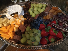 fruit chocolate and cheese on a silver platter