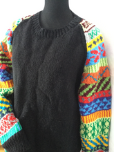 black hand knit pullover with multi color sleeves